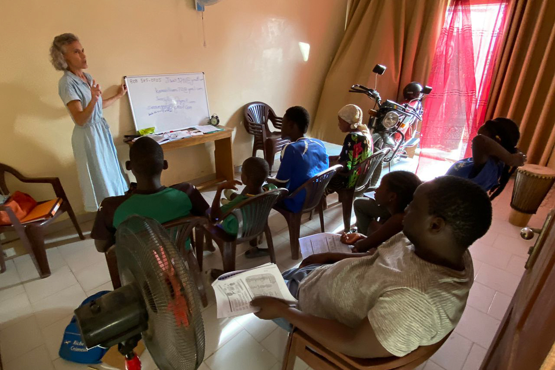 Kara teaches English to a group of church members